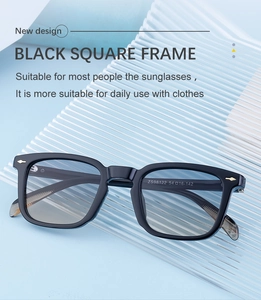 Detail of square black sunglasses with golden arrow metal decor and blue gradient lenses