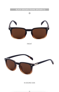 Close-up of vintage square black-brown sunglasses with gold arrow rivets and brown lenses
