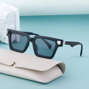 Retro square black sunglasses with white geometric accents and a cream leather pouch