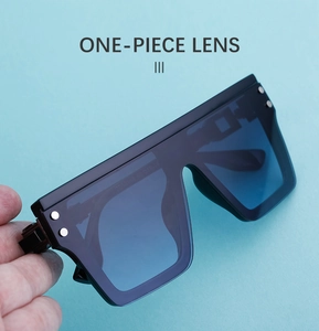 Vue détaillée des lunettes de soleil carrées noires avec rivets métalliques