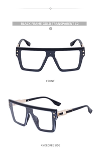 Détail de lunettes noires carrées avec charnières en métal doré et verres clairs