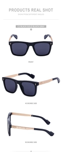 Detail view of square black sunglasses with gold metal temples and floral engraving