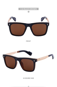 Detail of square black brown sunglasses with gothic engraved golden metal temples