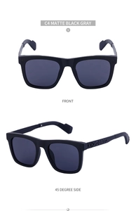 Detail of matte black sunglasses featuring ornate embossed patterns on metal temples