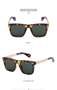 Detail view of demi square sunglasses with engraved gold metal temples and green lenses