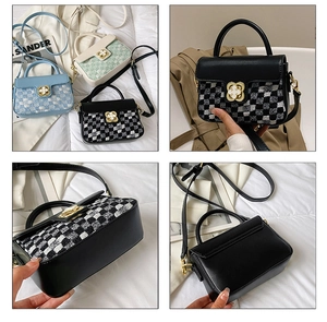 Detail of trendy checkerboard tweed handbag with a metal clover twist lock and shoulder strap