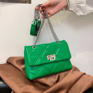 Bright green quilted crossbody bag with diamond stitching and silver chain strap