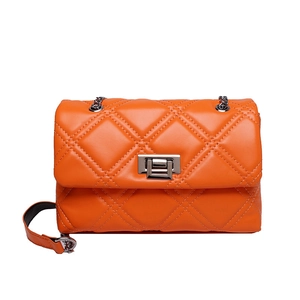 Fashionable orange quilted shoulder bag with metal chain strap and twist-lock closure