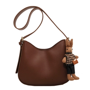 Classic dark brown semi-circle hobo shoulder bag with a cute knitted rabbit charm