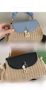 Detailed view of woven straw bag with leather flap, metal turn-lock and floral charm