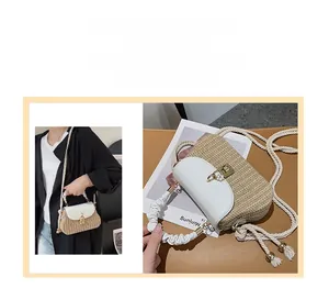 Detail of straw woven crossbody bag with white faux leather flap and golden twist lock