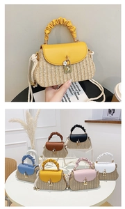 Detail of woven straw handbag with colorful leather lids and elegant floral charm