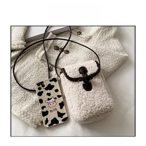 Faux shearling crossbody bag with leather trim and toggle, sized for a smartphone