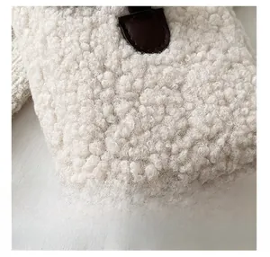 Detail shot of premium white shearling fabric with a brown leather decorative patch