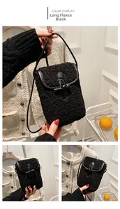 Detail view of long fur black mini crossbody bag with horn buckle and plush texture