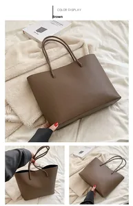 Detail view of brown lychee grain leather tote bag showing texture and side capacity