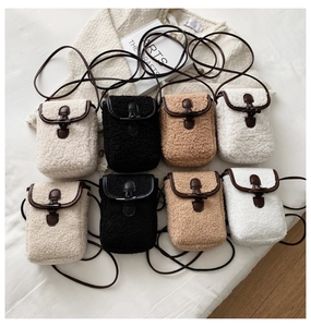 Detail of plush crossbody phone bags with horn buckle closure in four seasonal colors