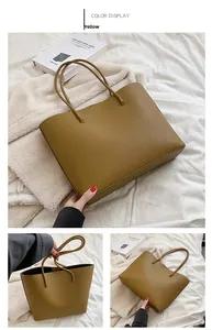 Detail of yellow lychee leather tote bag with long handles for stylish commuting
