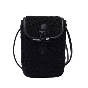 Chic black faux shearling crossbody bag with a classic horn buckle closure for women