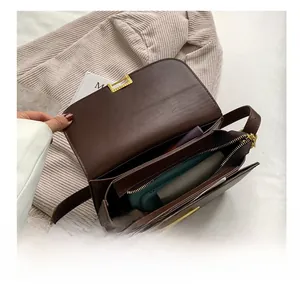 Detail of spacious dark brown leather bag interior showing compartments and storage