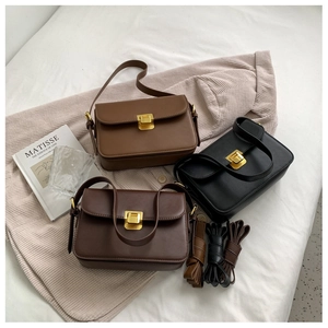 Three vintage leather crossbody bags in brown and black with gold metal buckles