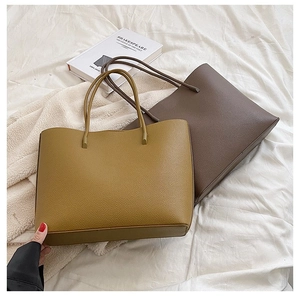 Minimalist large capacity leather tote bags in yellow and brown on white bedding