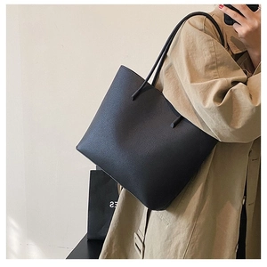 Minimalist black pebbled leather tote bag with double straps for daily commute