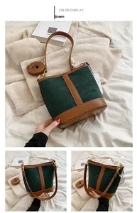 Detailed view of a vintage green suede bucket bag with brown leather trim and gold hardware