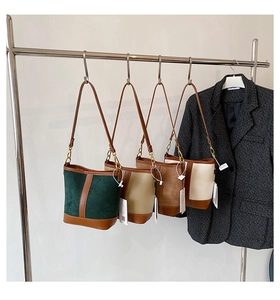 Collage of chic suede bucket bags in green, yellow, brown, and cream with leather trim