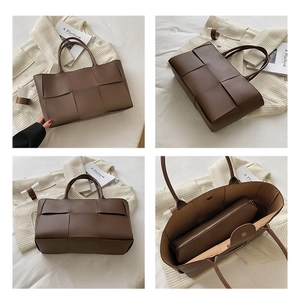 Detail view of large woven dark brown tote bag with magnetic closure and inner pouch