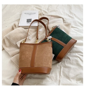 Detail of vintage suede patchwork bucket bags in camel and green with premium hardware
