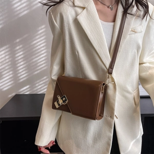 Brown rectangular flap crossbody bag featuring gold hardware and elegant chain detail