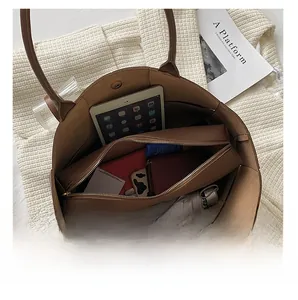 Internal structure of large brown tote bag showing organized compartments and capacity