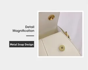 Detailsicht des goldenen Magnetverschlusses an einer weißen Leder-Umhängetasche