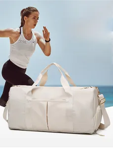 Detail of cream white sports bag featuring a side zipper compartment for shoes or wet items