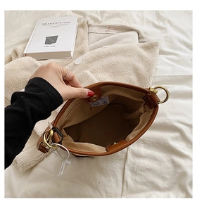 Top view of brown bucket bag showing magnetic closure and interior lining detail