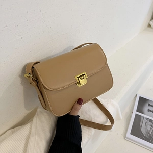 Minimalist khaki leather crossbody bag with golden metal buckle and sleek rectangular design