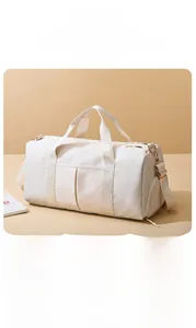 Detail view of water-resistant large travel bag with adjustable strap and gold hardware
