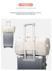 Detail view of the beige travel bag featuring a trolley sleeve for suitcase attachment