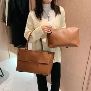 Fashionable caramel brown woven tote bag set with matching clutch in a chic autumn style