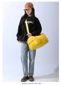 Bright yellow multi-functional gym bag worn by a model in a studio setting for short travel