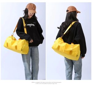 Close-up of bright yellow fitness travel bag with shoe compartment and adjustable strap