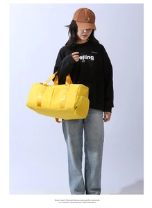 Large yellow gym bag with dry wet separation shown on model for travel and fitness