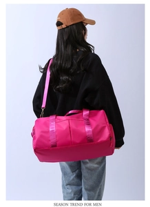 Model wearing large pink travel bag with detachable strap for fitness and yoga activities