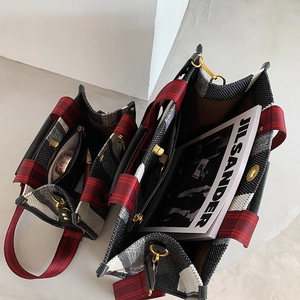 Classic red, black, and white checkered tote bags in large and small sizes with gold hardware