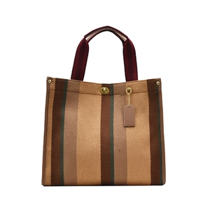 Classic vertical striped canvas tote bag with leather trim and golden twist lock closure