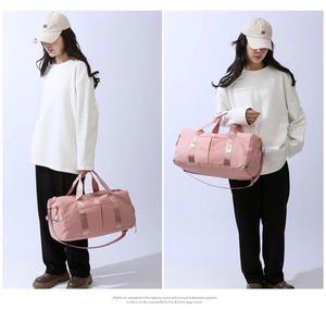 Pink travel bag detail showing padded handles and adjustable detachable shoulder strap