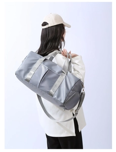 Detailed view of gray waterproof fitness bag with adjustable strap and reinforced handles