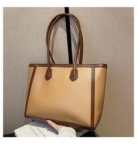 Detail of large two-tone tote bag with khaki body and dark brown leather straps