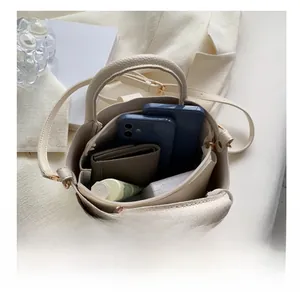Macro shot showing internal capacity of the cream bucket bag with multiple storage slots